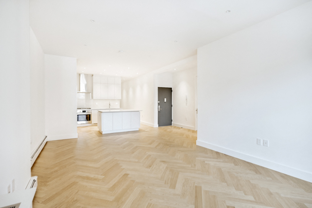 an empty living room and kitchen in a new home